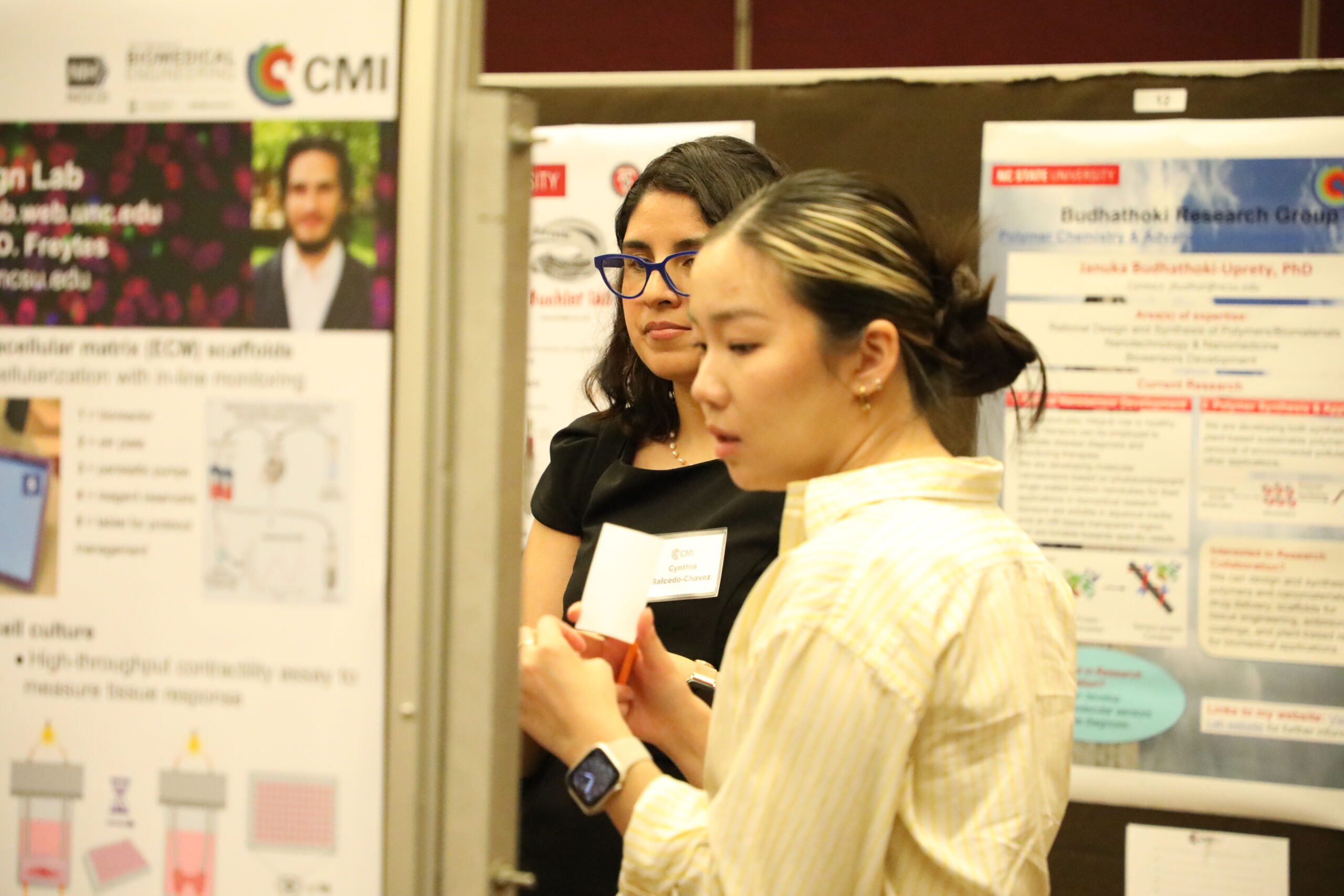 Two women look at a scientific poster